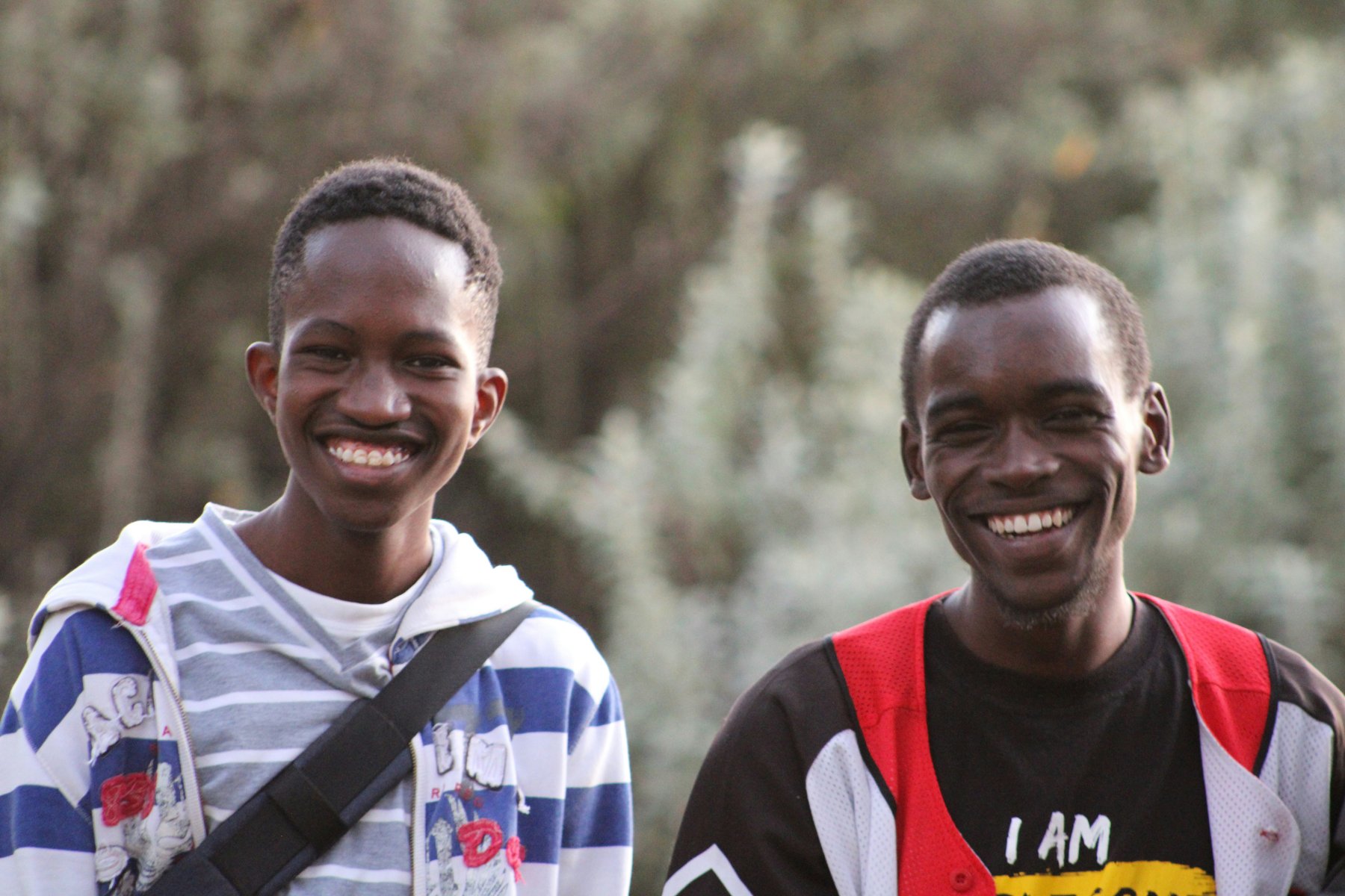 Two young men smiling together, representing opportunity and community