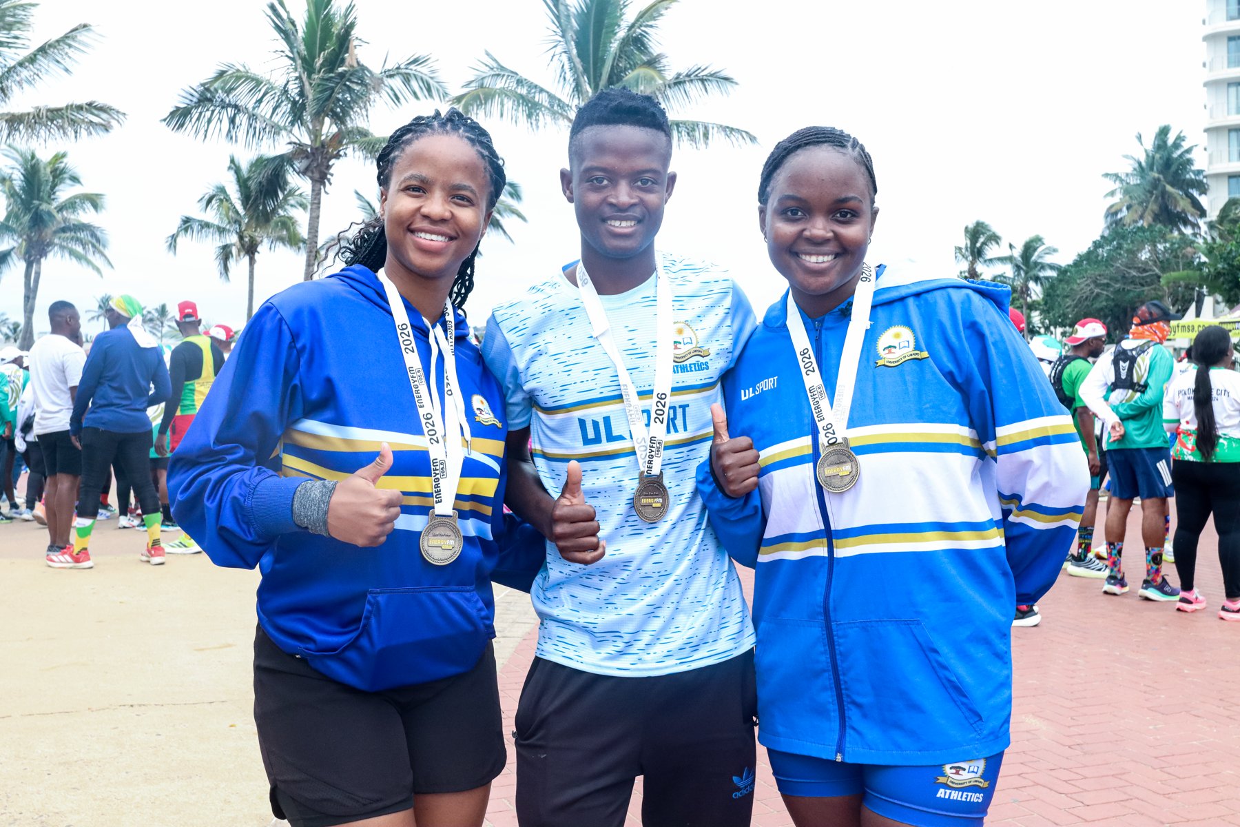 Young participants celebrating together at the Know Who You Are event, wearing University of Limpopo Sport branding and medals